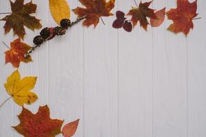 Background texture with old wooden table and yellow autumnal leaves. Autumn maple leaves on wooden background with copy space. Top view. photo