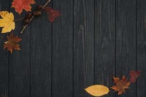 Background texture with old wooden table and yellow autumnal leaves. Autumn maple leaves on wooden background with copy space. Top view. photo