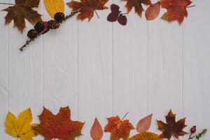 Background texture with old wooden table and yellow autumnal leaves. Autumn maple leaves on wooden background with copy space. Top view. photo