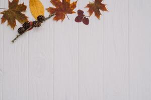 Background texture with old wooden table and yellow autumnal leaves. Autumn maple leaves on wooden background with copy space. Top view. photo