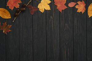 Background texture with old wooden table and yellow autumnal leaves. Autumn maple leaves on wooden background with copy space. Top view. photo