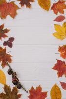 Background texture with old wooden table and yellow autumnal leaves. Autumn maple leaves on wooden background with copy space. Top view. photo