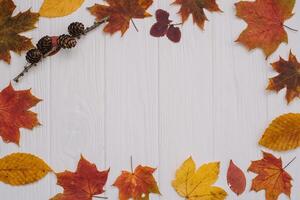 Background texture with old wooden table and yellow autumnal leaves. Autumn maple leaves on wooden background with copy space. Top view. photo