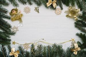 Christmas fir tree with decoration and glitters on wooden background. Christmas background on the white wooden desk photo