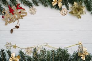 Christmas fir tree with decoration and glitters on wooden background. Christmas background on the white wooden desk photo