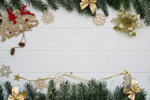 Christmas fir tree with decoration and glitters on wooden background. Christmas background on the white wooden desk photo