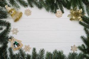 Christmas fir tree with decoration and glitters on wooden background. Christmas background on the white wooden desk photo