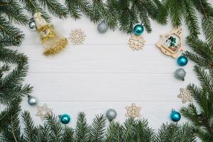 Christmas fir tree with decoration and glitters on wooden background. Christmas background on the white wooden desk photo