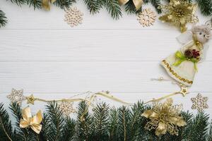 Christmas fir tree with decoration and glitters on wooden background. Christmas background on the white wooden desk photo