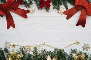 Christmas fir tree with decoration and glitters on wooden background. Christmas background on the white wooden desk photo