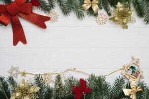 Christmas fir tree with decoration and glitters on wooden background. Christmas background on the white wooden desk photo