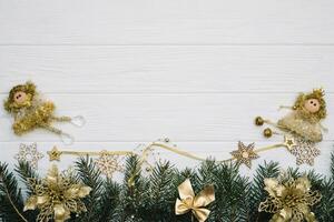 Christmas fir tree with decoration and glitters on wooden background. Christmas background on the white wooden desk photo