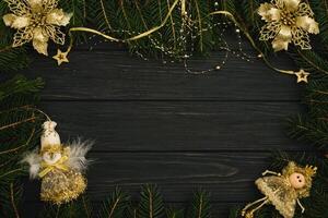 Christmas or New Year dark wooden background, Xmas black board framed with season decorations, space for a text, view from above photo