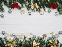 Christmas fir tree with decoration and glitters on wooden background. Christmas background on the white wooden desk photo