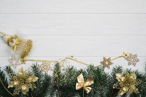 Christmas fir tree with decoration and glitters on wooden background. Christmas background on the white wooden desk photo