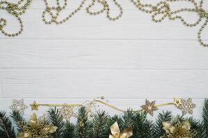 Christmas fir tree with decoration and glitters on wooden background. Christmas background on the white wooden desk photo