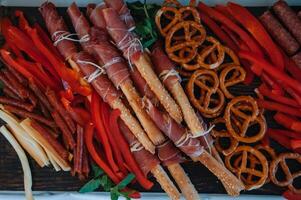 Beer Snack Mix with Dried Salted Seafood Top View and Flat Lay on Stone Table. Wine Snacks Buffet such as Spicy Squid, Mussels, Fish Fillet, cheese, nuts, sausages. photo