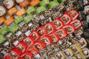 Decorated catering banquet table with different sushi rolls and nigiri sushi plate assortment on a party. photo