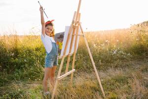 Little Girl Is Painting Picture Outdoors photo