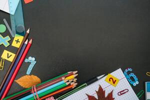 Back to school concept. School and office supplies on blackboard background. Flat lay with copy space photo