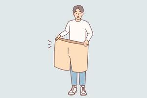 Lost weight man with big shorts in hands is surprised at size of own clothes from past vector