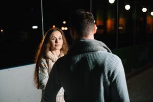 Date lovers in winter rink skates. Concept of Christmas holidays, caring for your loved one. photo