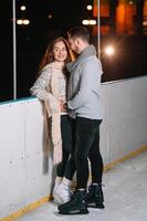 Date lovers in winter rink skates. Concept of Christmas holidays, caring for your loved one. photo