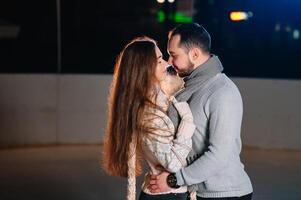 Date lovers in winter rink skates. Concept of Christmas holidays, caring for your loved one. photo