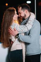 Date lovers in winter rink skates. Concept of Christmas holidays, caring for your loved one. photo