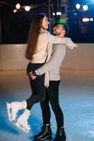 Date lovers in winter rink skates. Concept of Christmas holidays, caring for your loved one. photo