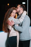 Date lovers in winter rink skates. Concept of Christmas holidays, caring for your loved one. photo