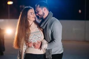 Date lovers in winter rink skates. Concept of Christmas holidays, caring for your loved one. photo