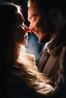 Happy attractive couple in a christmas market at night. Beautiful bokeh lights background. photo