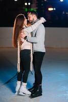 Date lovers in winter rink skates. Concept of Christmas holidays, caring for your loved one. photo