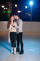 Date lovers in winter rink skates. Concept of Christmas holidays, caring for your loved one. photo