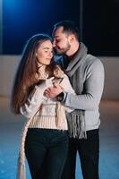 Date lovers in winter rink skates. Concept of Christmas holidays, caring for your loved one. photo