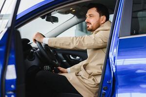 Attractive elegant happy man in good car photo