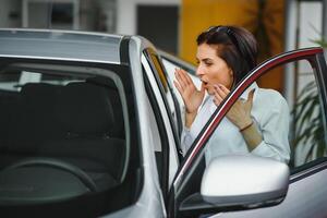 business woman in a car dealership. concept of successful woman photo