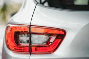 Back view of new white car. Closeup headlights of car. White premium city crossover, luxury SUV rear light closeup. Car lamp close-up. photo