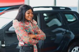 Women buying the car. Ladies in a car salon. Black girls near white car photo