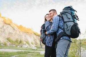 happy young couple hiking in mountain photo