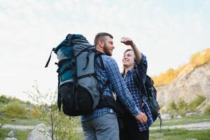 happy young couple hiking in mountain photo