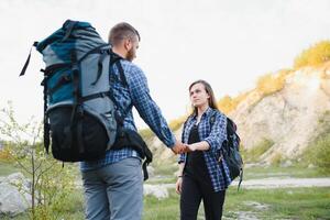 happy young couple hiking in mountain photo