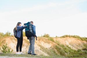 happy young couple hiking in mountain photo