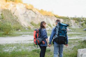 happy young couple hiking in mountain photo