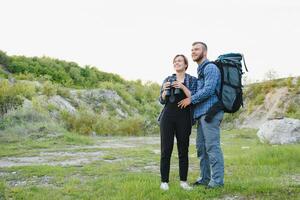 happy young couple hiking in mountain photo