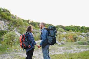 happy young couple hiking in mountain photo