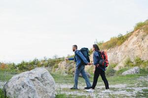 happy young couple hiking in mountain photo