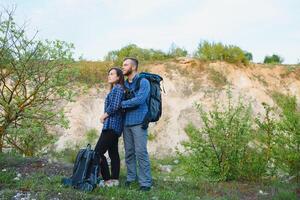 happy young couple hiking in mountain photo