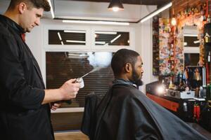 Young African-american man visiting barbershop photo